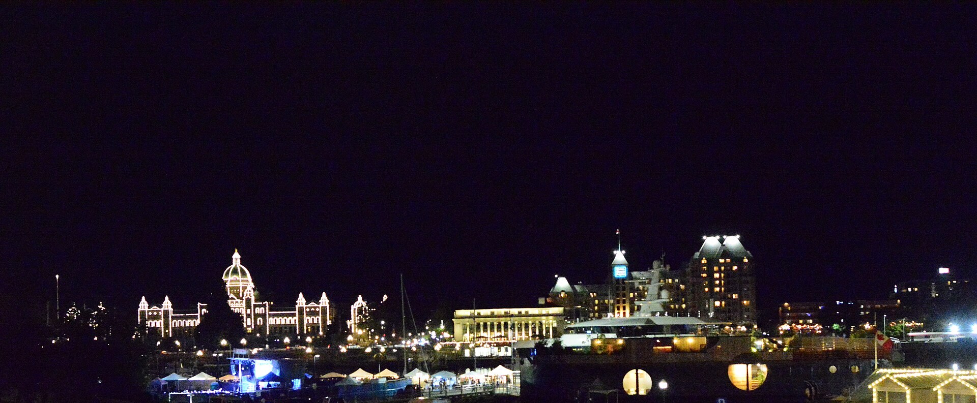 British Columbia Parliament Buildings lit at night across Victoria Inner Harbour